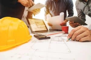 3 Contractors working on a Construction Plan