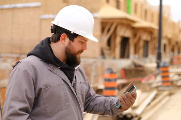 A Construction Worker Holding a Phone