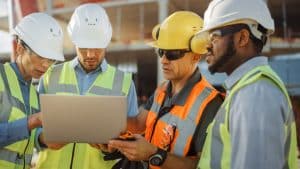 4 Construction Workers with a Notebook