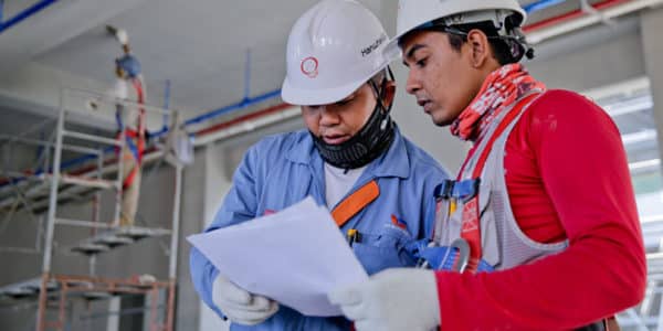 2 Workers looking at a Construction Plan