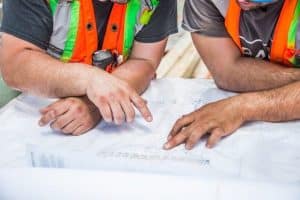 2 Men Analyzing Construction Plans