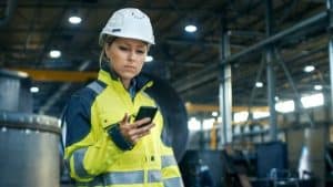A woman in construction site with her phone