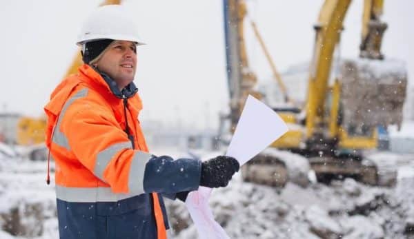 Contractor on a construction site in a snowy day
