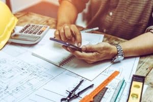 A Person Working on Construction Plans