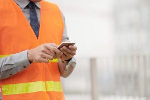 a contractor holding an iphone