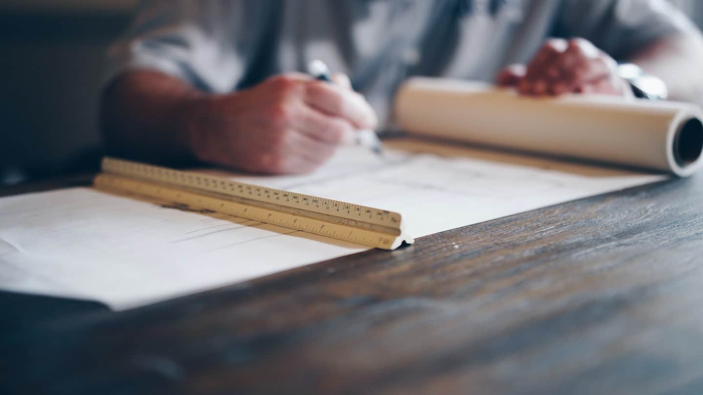 Man Working on Construction Blueprints